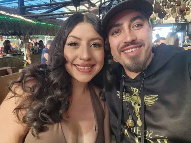 Diana and Jeremy smiling together, the founders of Oak & Ember